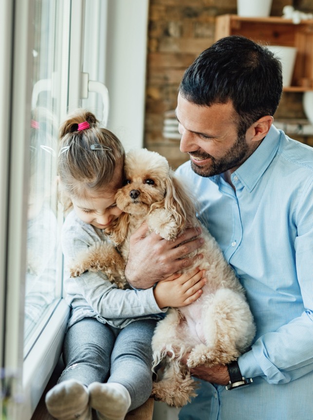 Little girl embracing dog
