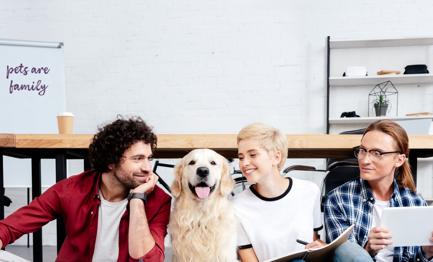 Three people with Golden Retriever